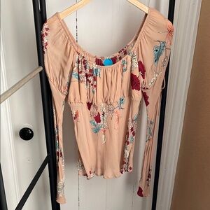 Floral Women's peasant Blouse in on tan background